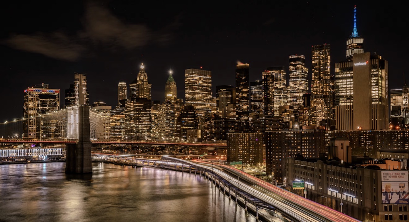The Manhattan skyline and Brooklyn Bridge lit up at night